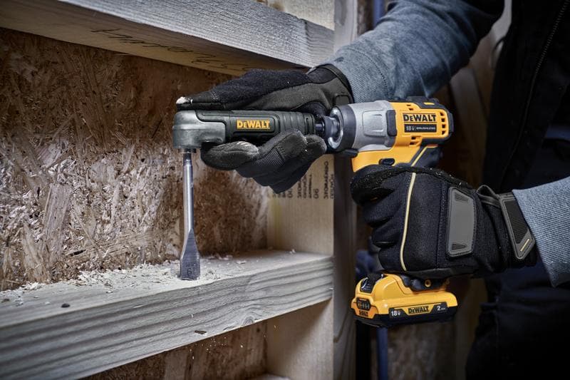 A person wearing work gloves using a DEWALT cordless drill with an attachment to drill into a wooden beam.