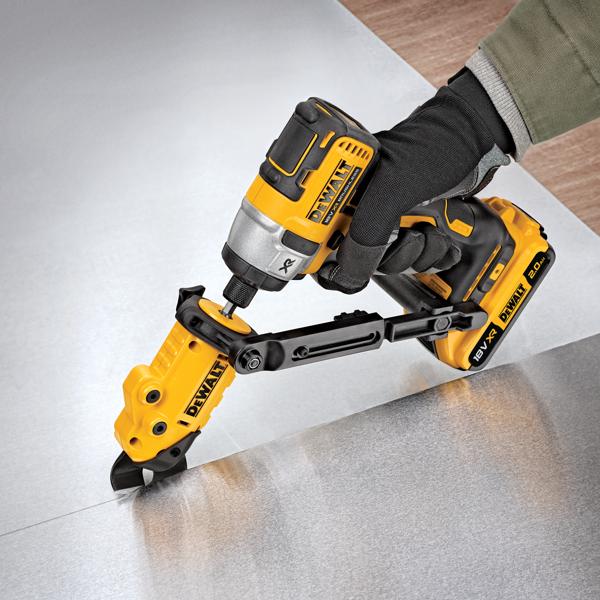 A person wearing gloves uses a DEWALT DT70620 power tool with an attachment to cut through a sheet of metal.